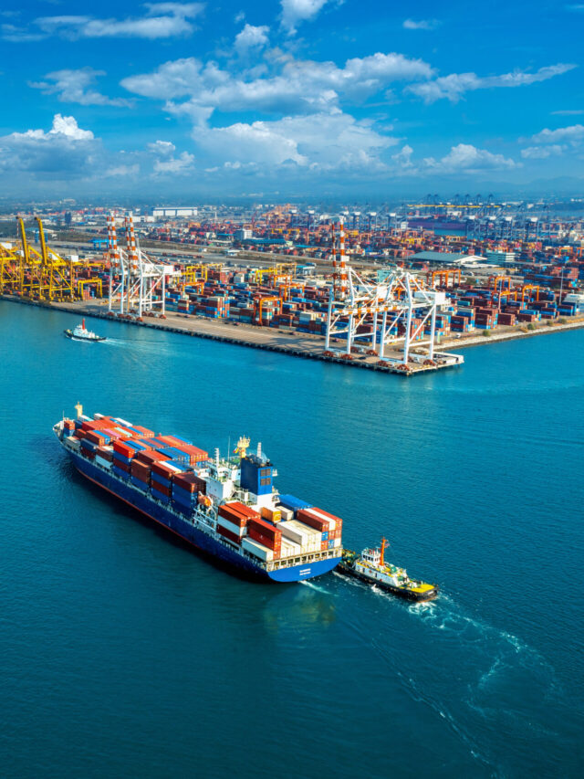 Aerial view of cargo ship and cargo container in harbor.